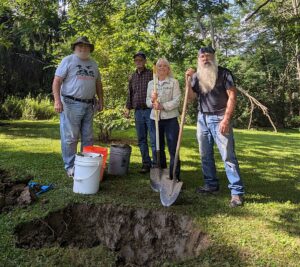 Photograph showing Vincent Martonis, property owner Stefan Mayr, Bonnie Brinson, and Ron Nasca digging clay at Haven & Kenyon site.