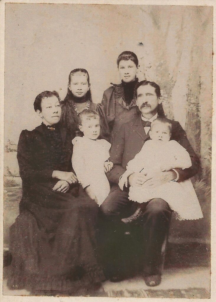 William E. Johnson family portrait. Seated from left to right are Cora, daughter Martha, William, and daughter Frankie on William's lap. Standing are daughters Grace and Licenna. (Photo courtesy of William S. and Susan Rice)